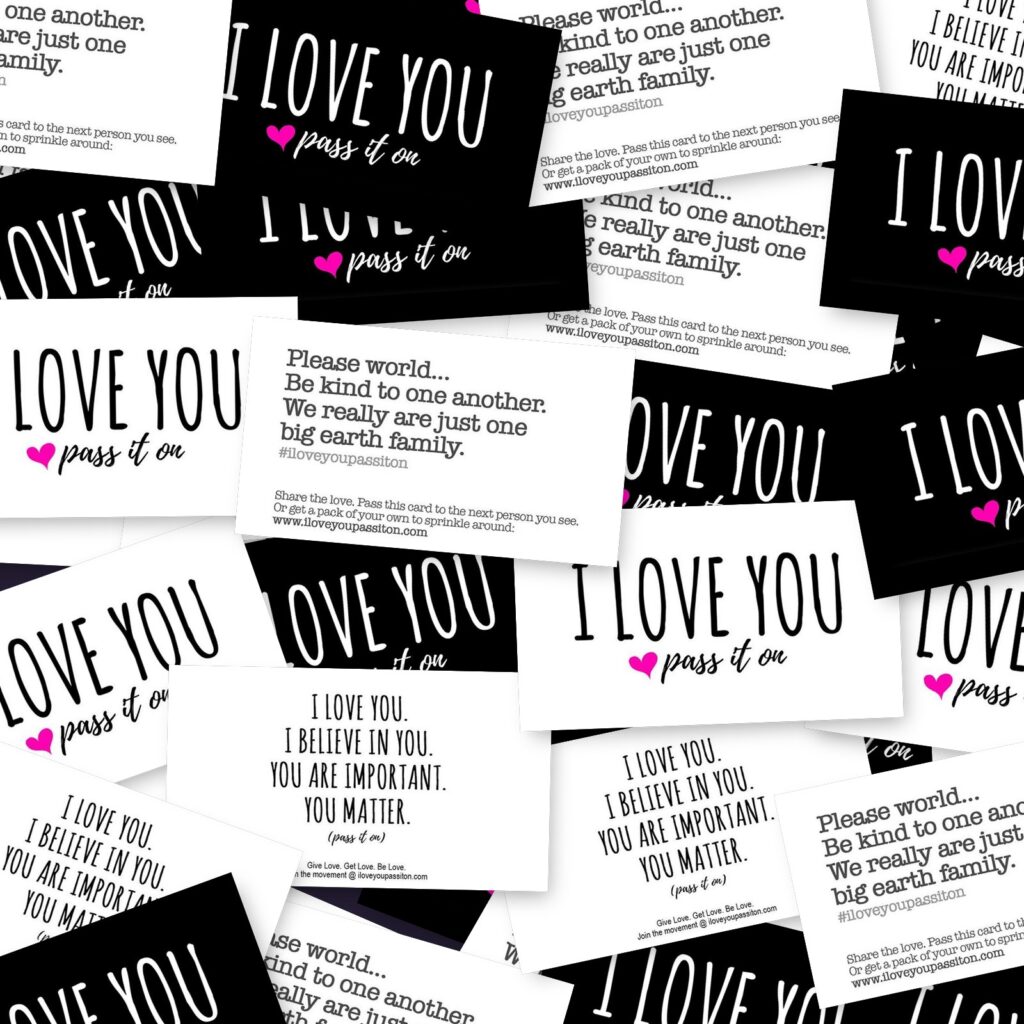 A scattered pile of I Love You Pass It On love cards