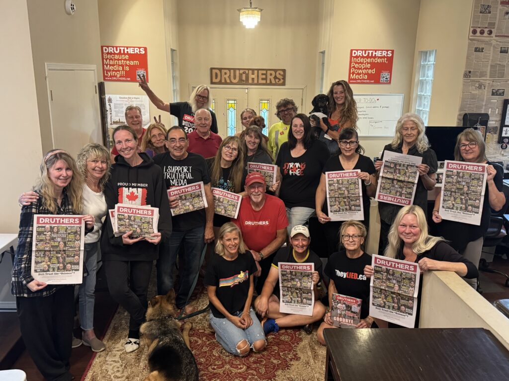 The Druthers volunteer family, holding up copies of Druthers
